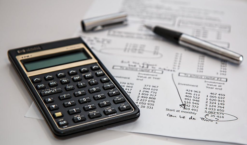 black-calculator-near-ballpoint-pen-on-white-printed-paper-53621 Close-up of financial documents with calculator and pen, ideal for business management themes.